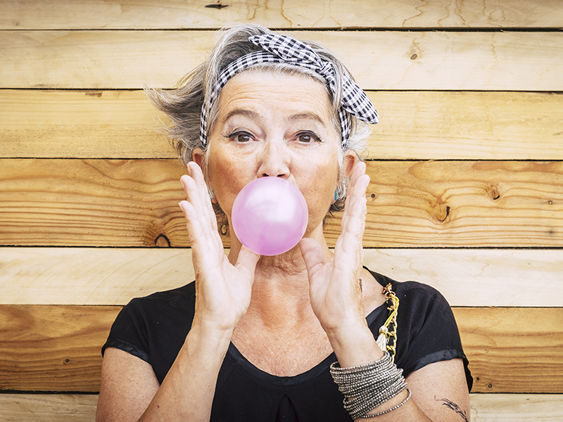 Retired woman blowing a bubble